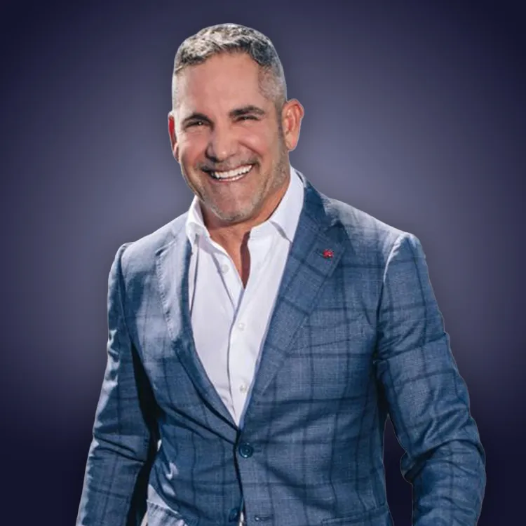 Man with crossed arms wearing a black Tether shirt standing confidently in front of a wall with Tether logos.